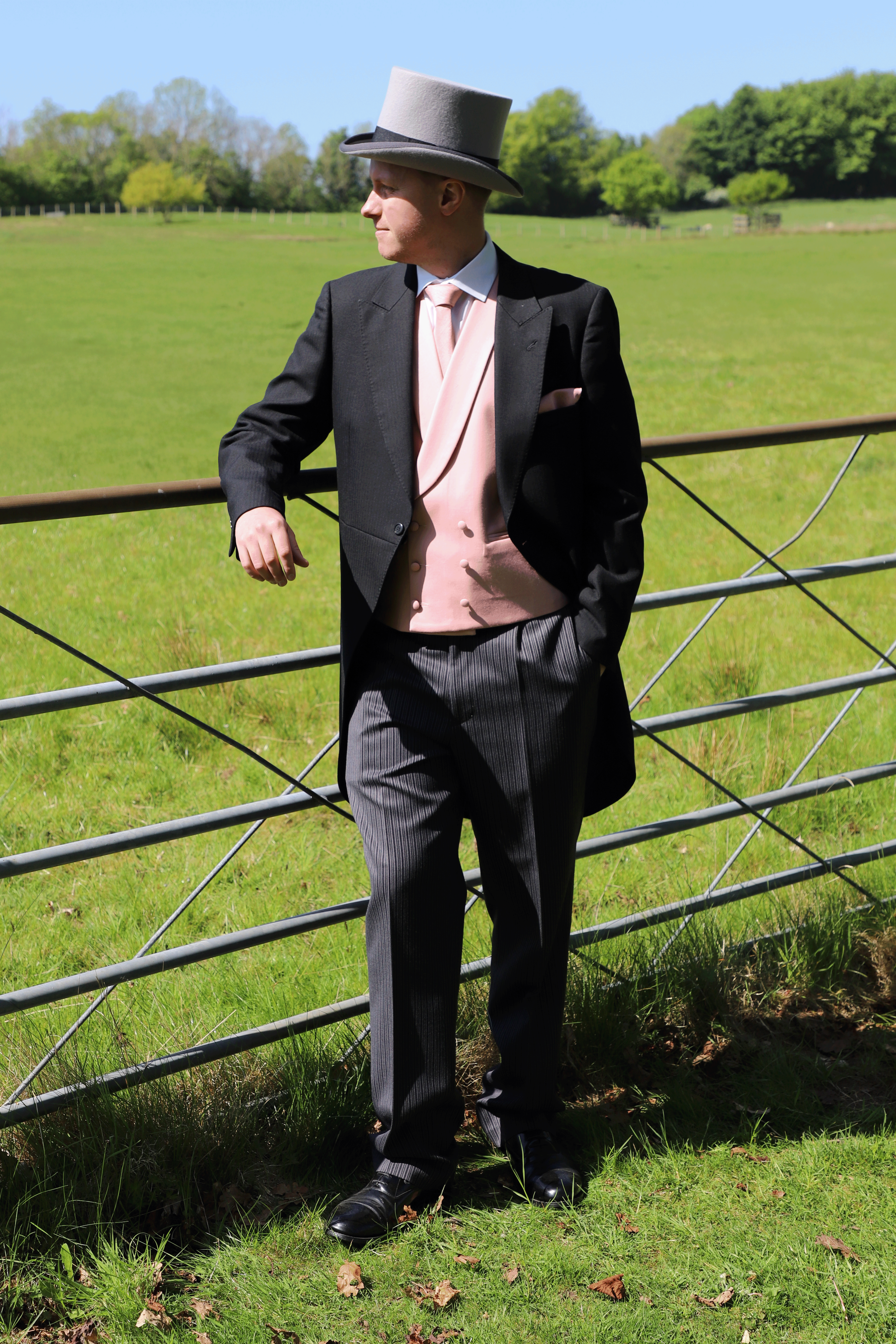 Model wears Black Tailcoat, Pink Double Breasted & Grey Stripe Trousers Hire Package