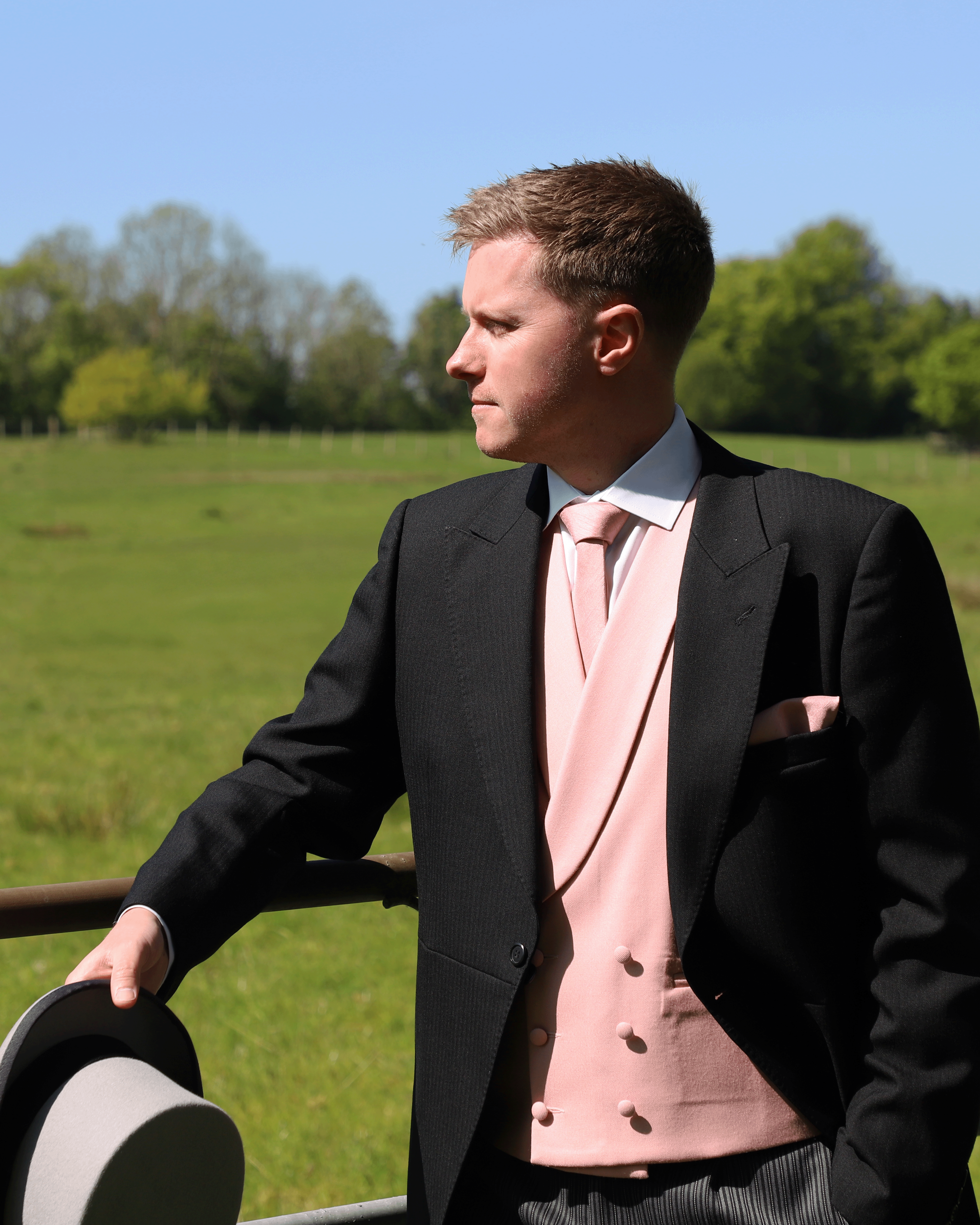 Model wears Black Tailcoat, Pink Double Breasted & Grey Stripe Trousers Hire Package