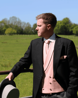 Model wears Black Tailcoat, Pink Double Breasted & Grey Stripe Trousers Hire Package