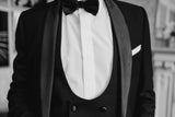 Close-up of black tuxedo, bow tie and white shirt.