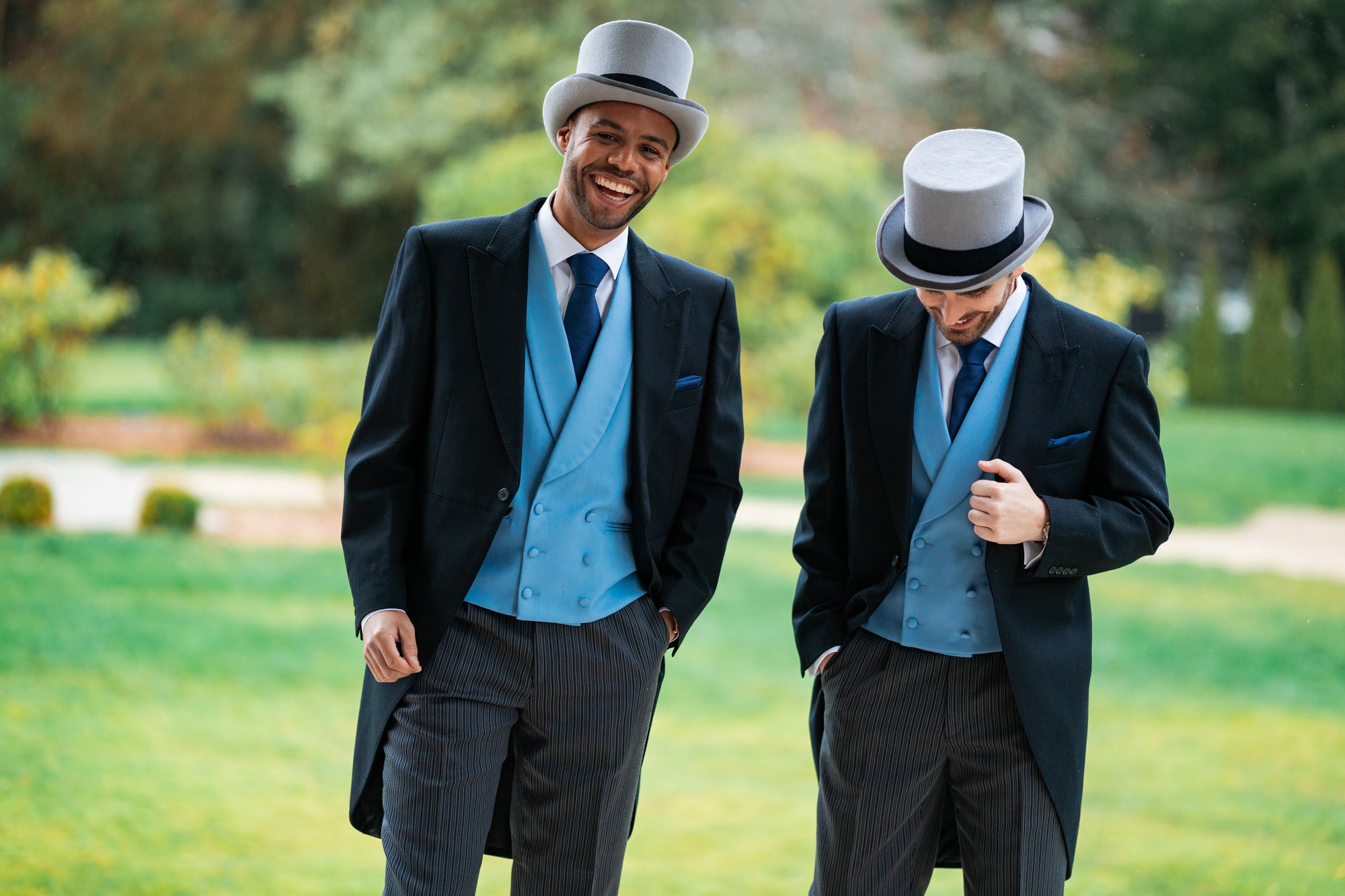 Royal Ascot suit hire morning suits with blue waistcoats and top hats in garden setting