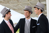 Three men in Royal Ascot attire with top hats standing outdoors.