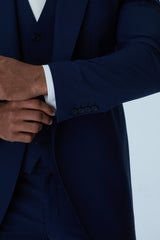 Navy blue tailcoat with a white shirt on a light gray background