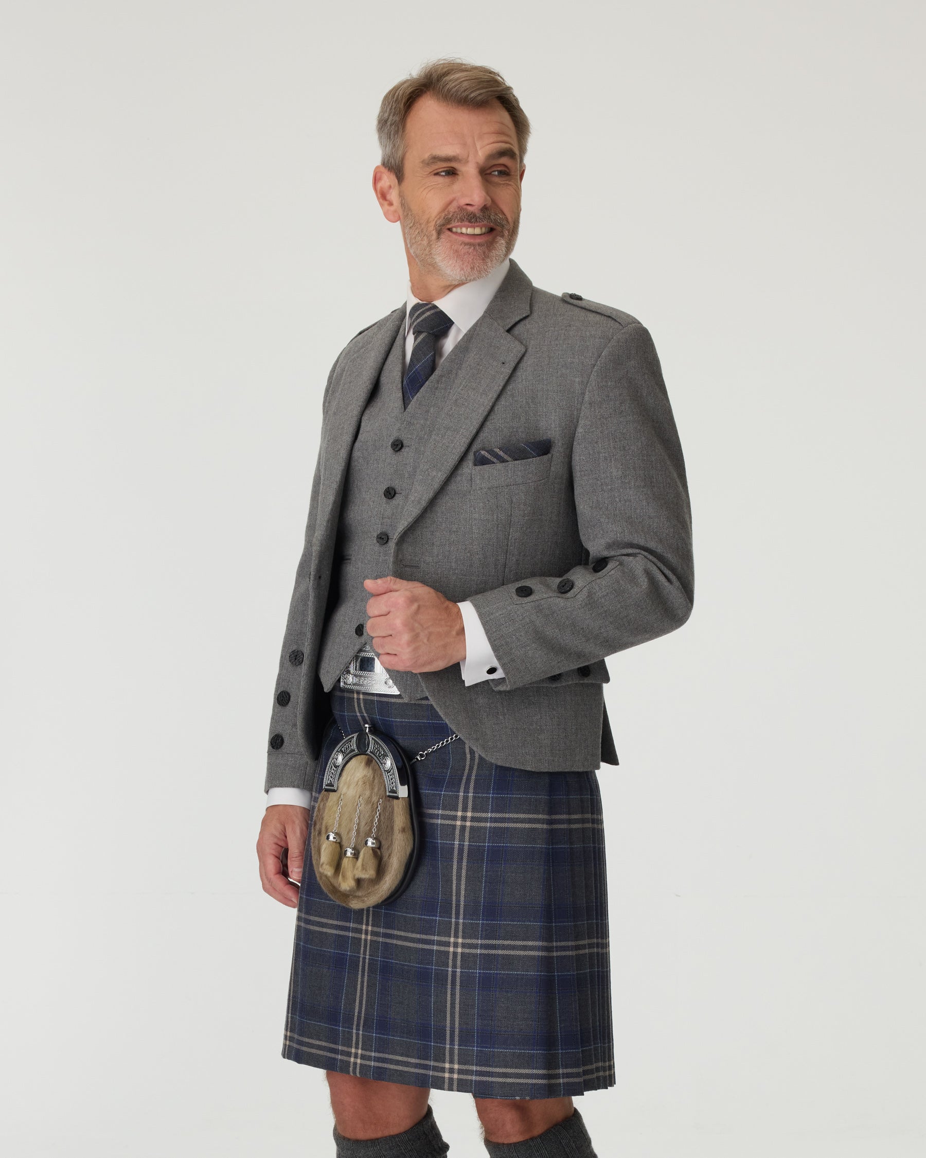 Man wears Charcoal Tweed Jacket with Highland Stor
m 3/4