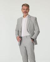 Man wearing a gray suit with a white shirt on a light gray background