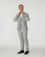 Man wearing a gray checkered suit with a white shirt on a white background