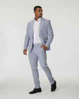 Man wearing a sky blue suit with a white shirt on a white background