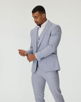 Man wearing a sky blue checkered suit on a white background