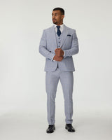 Man wearing a sky blue suit with a blue tie on a white background